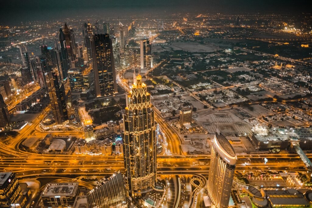 The Burj Khalifa illuminated at sunset with an orange sky